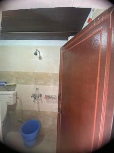 a bathroom with a toilet and a shower at Pahari Trekkers in Nainital