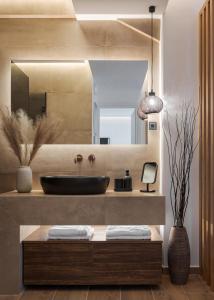 a bathroom with a sink and a mirror at Vouliagmeni Olivomare Suite in Athens