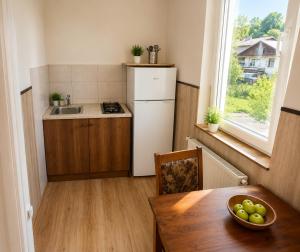 a kitchen with a table and a sink and a window at Tuz House R7 in Bakuriani
