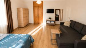 a living room with a couch and a table at Tuz House R7 in Bakuriani