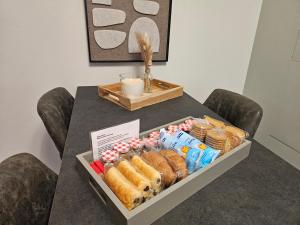 a table with a tray of bread and pastries on it at EdenGHouse in Cordenons