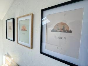 two framed pictures hanging on a wall at La Palmeraie, Duplex in Bar-le-Duc +3 photos