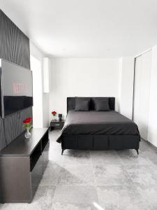 a bedroom with a large bed and a table at Rochetaillée Secret Spa in Saint-Étienne