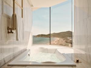 a bath tub with a view of the ocean at BLESS Ibiza The Site - New Opening 2026 in Playa d'en Bossa