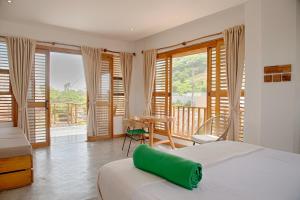 a bedroom with a bed and a table and windows at Casa Mambo Salinas in Santa Verónica +75 photos