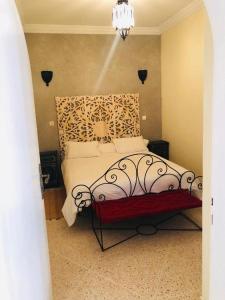 a bedroom with a bed with a wrought iron headboard at Villa Azal in Mirleft +19 photos