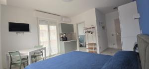 a bedroom with a bed and a table and a desk at Casa di Bea 2 in Ventimiglia