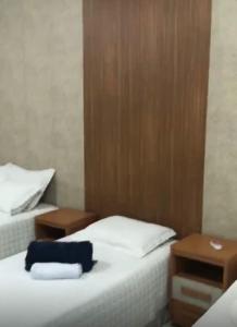 a room with two beds and two night stands at Hotel Familiar in Salinas +3 photos