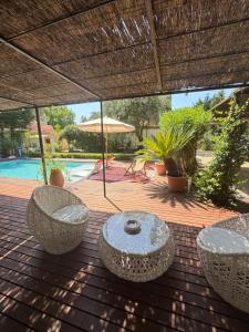 a patio with a table and chairs on a wooden deck at Maison AdriAnna in Vedène
