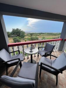 a balcony with chairs and a table with a view at Lydia in Vrsi