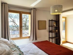 a bedroom with a bed and a window at Le Vernay en Savoie - Petit Hôtel Nature in Saint-Maurice-de-Rotherens