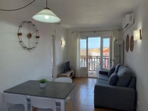 a living room with a couch and a table at Costa Arenal 112 in Arenal d'en Castell