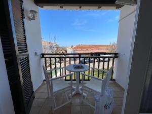 a balcony with a table and two chairs on it at Costa Arenal 112 in Arenal d'en Castell