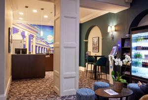 a lobby of a hotel with a barber shop at Thistle London Bloomsbury Park in London