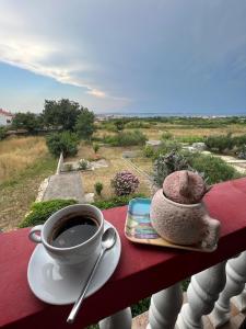 a cup of coffee and a teddy bear sitting on a table at Lydia in Vrsi