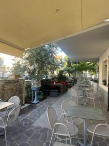 a patio with tables and chairs on a patio at Residence Abamar in Rimini