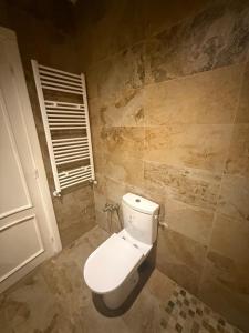 a bathroom with a white toilet in a room at Aouina Stay in El Aouina Station +27 photos