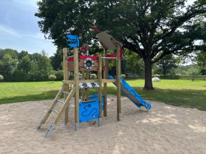 a playground with a slide and a ladder at CAMPING LES EMBRUNS 3* in Camoël