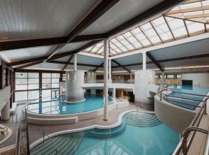 a large indoor swimming pool in a building at Panonska hiška - Panonian nest - vključeni 2 kopalni karti za Terme3000 in Moravske-Toplice