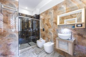 a bathroom with a shower and a toilet and a sink at Bologna Rooms in Naples