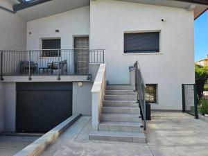 a house with a staircase and a garage at EdenGHouse in Cordenons