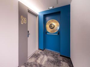 a blue door with a gold door knocker on it at Ibis Murcia in Murcia