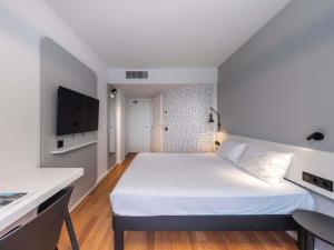 a small room with a bed and a desk at Ibis Murcia in Murcia +44 photos