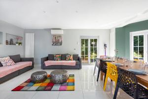 a living room with a couch and a table at Villa Cerf - SPA Privé, Climatisation, Sauna, Borne d'arcade, Babyfoot in Ittenheim