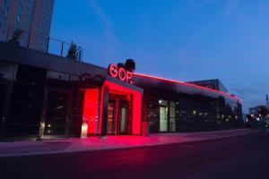 a store with a red sign on the side of a building at Radisson Blu Hotel, Bonn in Bonn
