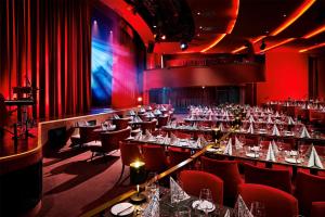 a dining room with tables and chairs and red lighting at Radisson Blu Hotel, Bonn in Bonn +43 photos
