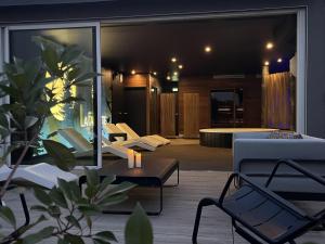 a living room with a couch and a table at Best Western Plus La Fayette Hotel et SPA in Épinal