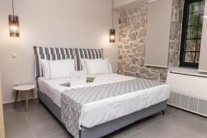 a bedroom with a bed with a laptop on it at Argolis Rodies Homes in Kilada