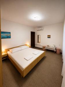 a bedroom with a large bed in a room at Rooms Nada in Senj +17 photos