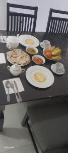 a black table with plates of food on it at Mystik Muthu View Haputale in Haputale