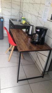 a wooden table in a kitchen with a sink at casa la luz Orotina in Orotina