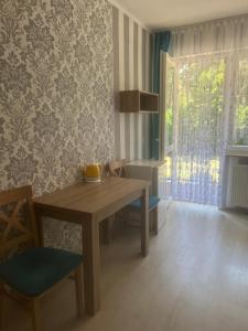 a dining room with a table and chairs and a window at Baracuda in Dębki