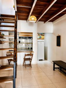 a kitchen with a table and a refrigerator at MeldoMar chalé aconchegante na Pipa in Pipa +14 photos