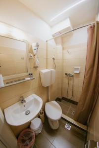 a bathroom with a sink and a toilet and a shower at Anna Christina in Kamena Vourla +45 photos