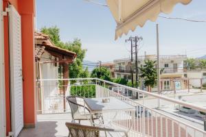 a patio with a table and chairs on a balcony at Anna Christina in Kamena Vourla
