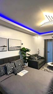 a living room with a bed and a couch at Club Balai Isabel Front Taal Lake & Volcano View in Talisay +31 photos