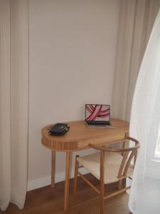 a small wooden table with a laptop on it at Apartment Marta Tivat in Tivat