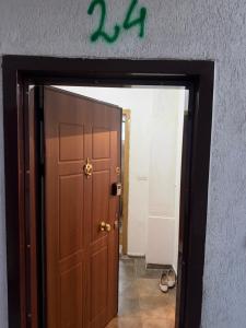 a door leading into a hallway with a sign above it at Ring Urban Apartment in Kosovo Polje