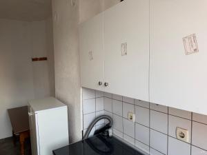 a kitchen with a sink and a refrigerator at Ring Urban Apartment in Kosovo Polje