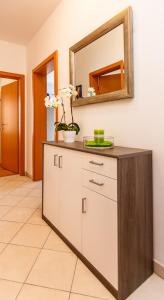 a bathroom with a vanity with a mirror at Mare & Mons Seafront Apartments in Malinska +85 photos