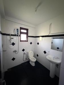 a bathroom with a toilet and a sink at Mystik Muthu View Haputale in Haputale