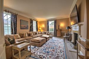 a living room with a couch and a fireplace at Abbey House by Group Retreats in Saffron Walden