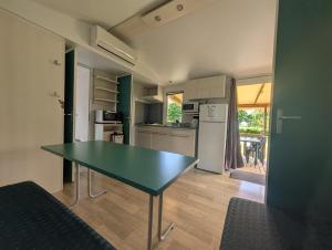 a kitchen with a table in the middle of a room at Camping de Graçay in Graçay