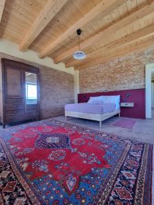 a bedroom with a bed and a brick wall at Ca' Sinoira in Nizza Monferrato