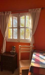 a bedroom with a bed and a window at Tale Cabaña de campo in Huacalera