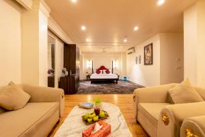 a living room with two couches and a bed at The Saga Hotel Green Park in New Delhi +93 photos